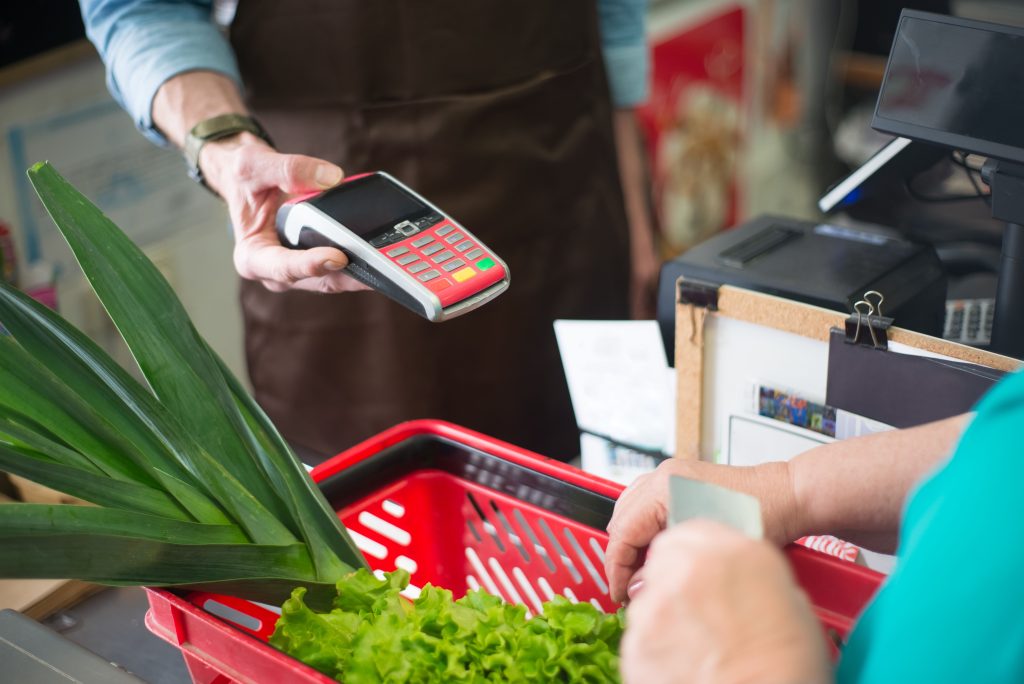 Person paying in supermarket