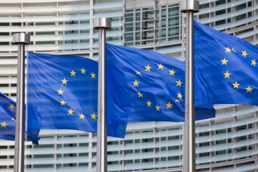 EU flags fluttering in the wind in front of the Commission headquarters