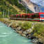 Travelling by train (pictured running alongside a lake) can make for the perfect sustainable summer holiday.