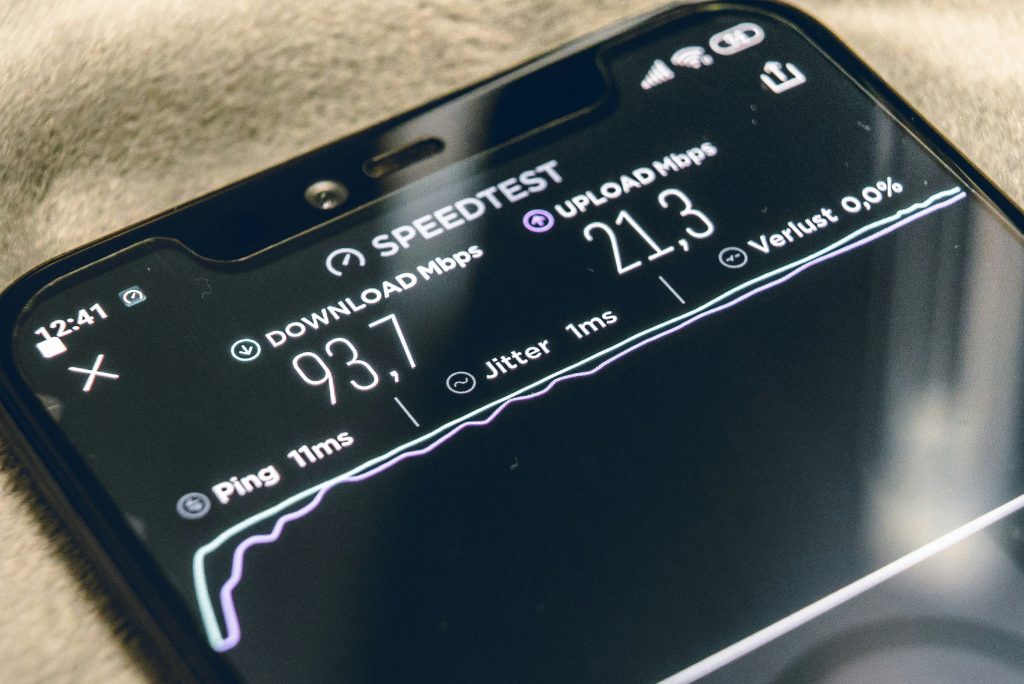 Top of phone screen showing speedtest results on download Mbps and upload Mbps. Source: Unsplash